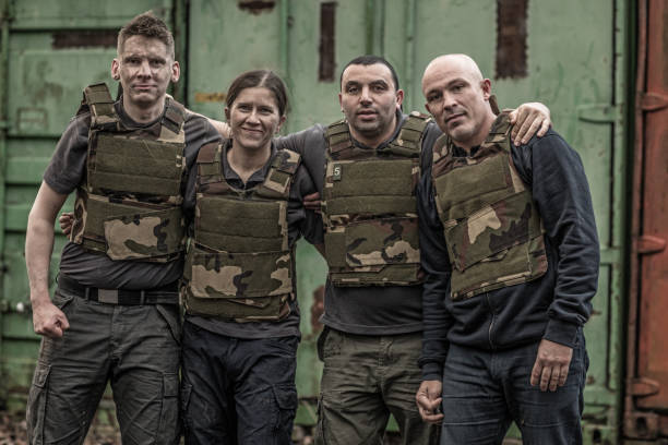 istock Krav Maga fighting group posing for team picture in grimy outdoor setting 913094872