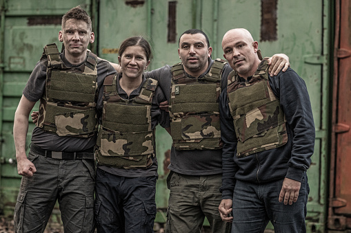 Krav Maga fighting group posing for team picture in grimy outdoor setting