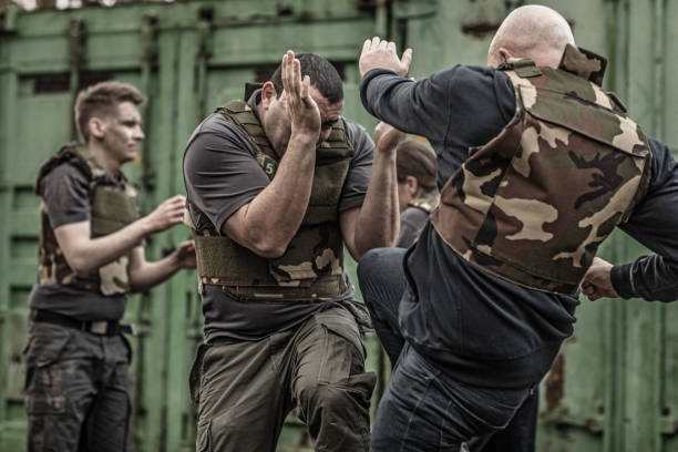 istock Krav Maga fighting group sparring during training session in grimy outdoor setting 913094886