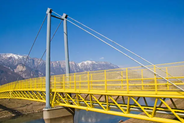 The popular cycle path through South Tyrol and the Adige Valley leads over this yellow, colorful bridge