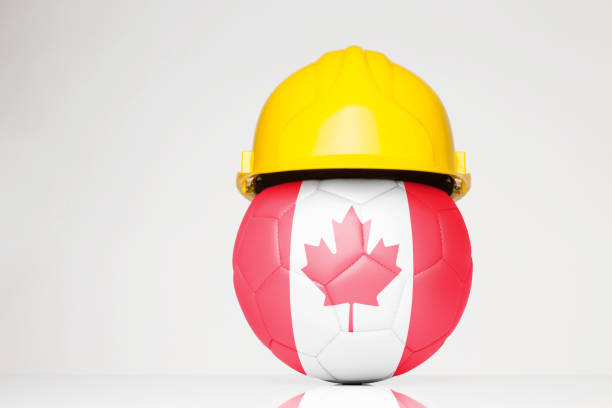 istock football wearing a yellow hard hat 913101684