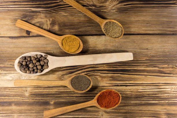 istock Assorted spices in wooden spoons on a table 913102706