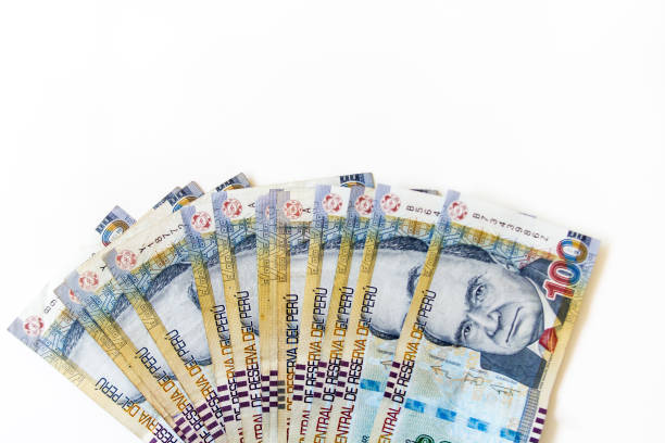 Macro of 100 Peruvian soles bills placed in fan on white background viewed from above
