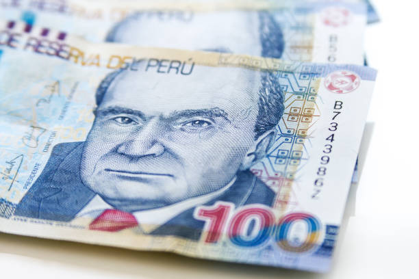 Macro of 100 Peruvian soles bills placed in fan on white background