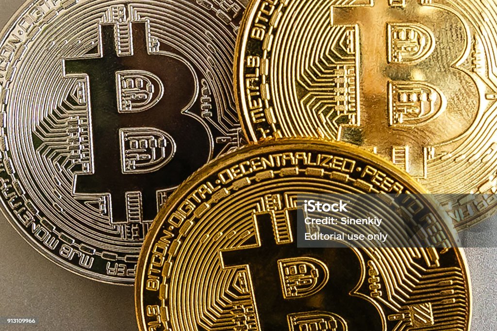 Bitcoin golden coins on a dollar Kiev, Ukraine - December 03, 2017 : Bitcoin upright on a laptop keyboard Bitcoin Stock Photo