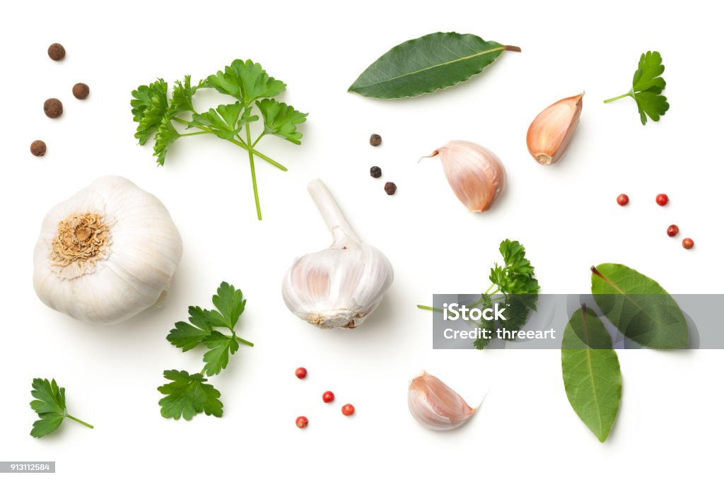 Garlic, Bay Leaves, Parsley, Allspice, Pepper Isolated on White Background Garlic, bay leaves, parsley, allspice and pepper isolated on white background. Top view Spice Stock Photo