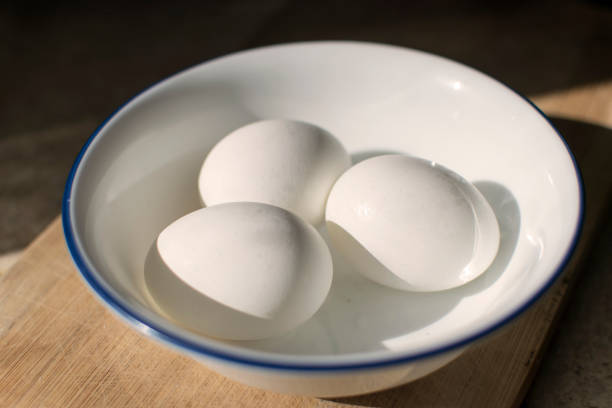 istock Three White Eggs in a Bowl on Top of a cutting board 913114122
