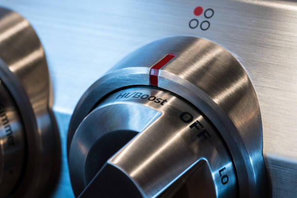 Closeup view of a knob and control panel button on a washing machine. Home appliance