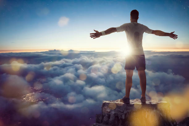 Man over the clouds spreading his arms