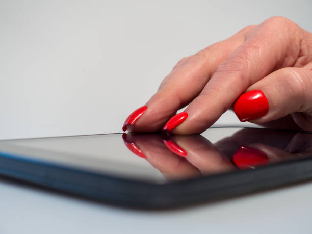 istock Extreme close up older woman using internet on her touch device 913122278