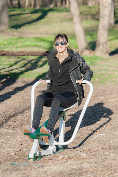 istock exercising on a machine at the outdoor gym 913122306