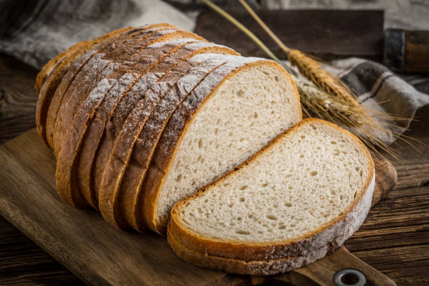 istock Sliced loaf of bread on a chopping board. 913124836