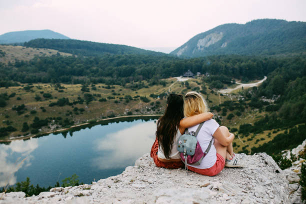 istock Two women enjoying a beautiful view in the nature 913125032