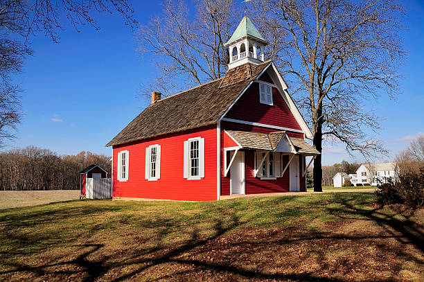 Little Red Schoolhouse Horizontal This is a restored one room school located in Talbot county Maryland. Notice the outhouse in the rear. schoolhouse stock pictures, royalty-free photos & images