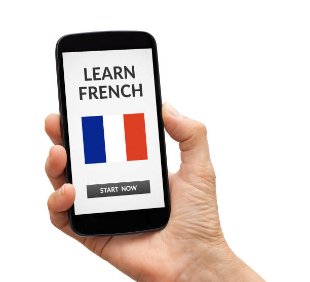 istock Hand holding smart phone with learn French concept on screen 913125474