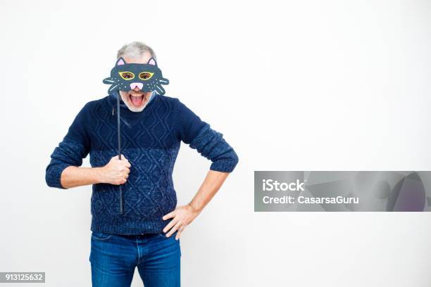 Mature Man Hiding Behind A Paper Cat Mask On A Stick Mouth Wide Open Stock  Photo - Download Image Now - iStock