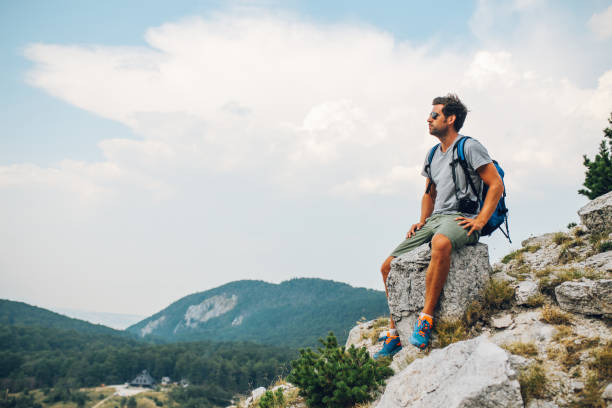 istock Young man enjoying a beautiful view in the nature 913131296
