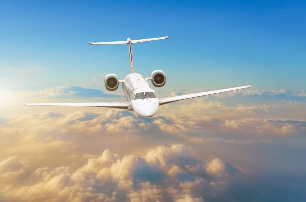 istock Flying airplane above the clouds horizon sky with bright sunset colors. 913131592