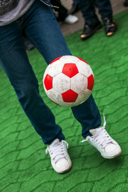 Man juggling a soccer ball, a competition among fans