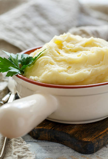 istock Mashed potatoes and green parsley in a ceramic bowl. 913136296