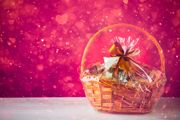gift basket with festive heart particles, purple background
