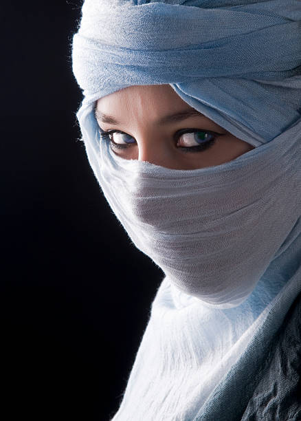 Portrait of a girl with big eyes wearing a burka, black and white photo