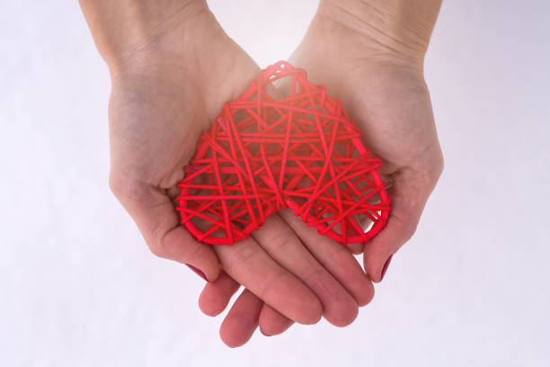 istock Concept for Valentine's Day, wedding: hands holding a red heart. 913166220