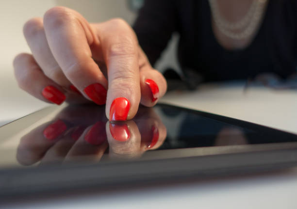 istock Extreme close up older woman using internet on her touch device 913175020