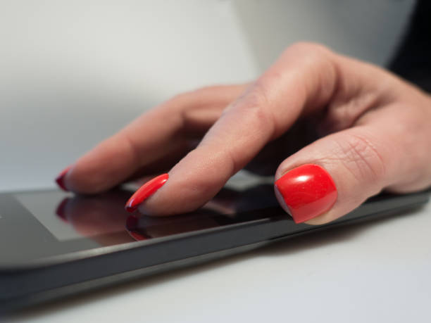 istock Extreme close up older woman using internet on her touch device 913175126