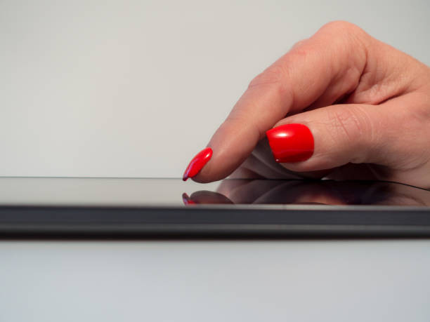 istock Extreme close up older woman using internet on her touch device 913175134