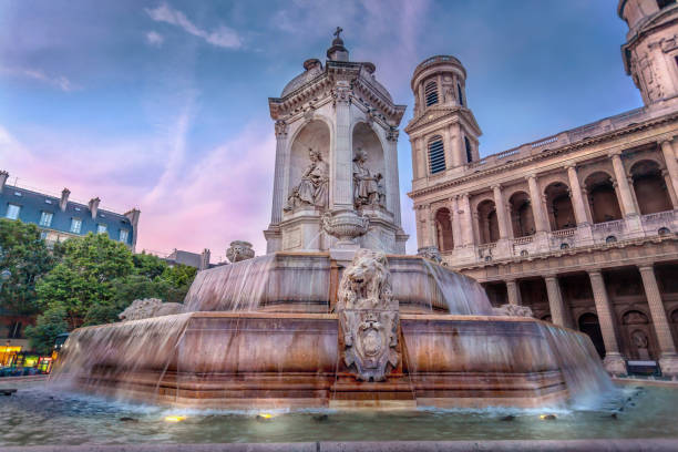 Saint-Sulpice Church in Paris, France. Saint-Sulpice Roman Catholic Church and Fountain in Paris, France. Featured in Dan Brown's book, The Da Vinci Code. Taken at Dusk in the  Summer time. luxembourg paris stock pictures, royalty-free photos & images