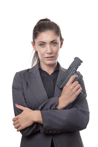 business woman holding a gun looking at camera