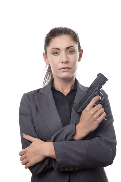 istock business woman with hand gun 913178374