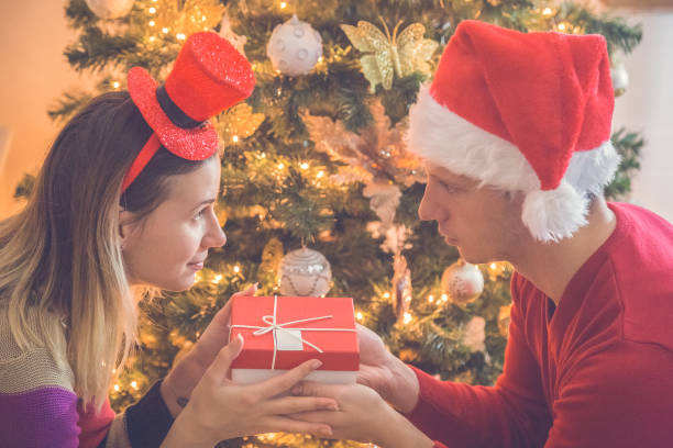 istock Couple Exchanging Christmas Gifts 913179482