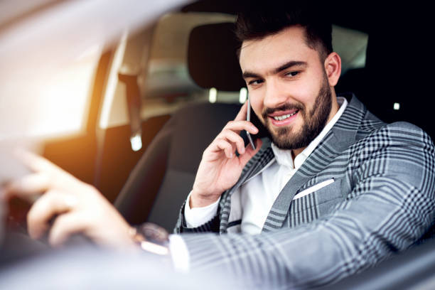 istock Nice guy in stylish suit talking over phone with smile 913185696