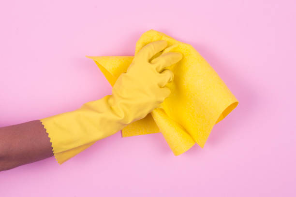 istock Hand in yellow protective glove cleaning with rag 913185768