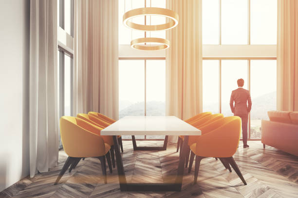 istock White dining room corner, yellow chairs side man 913187016