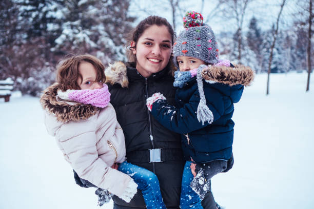 istock Mother and daughters having fun on a winter day 913189690