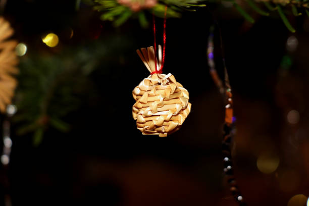 istock The christmas a straw adornment hanging on the tree 913189848