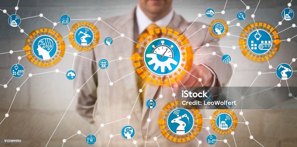 Manager Reconfiguring Industrial IoT Assets Unrecognizable manager is reconfiguring industrial assets in real-time. Concept for industry 4.0, reconfigurability, productivity, CPS, computer-aided manufacturing, cyber-physical systems and AI. Learning Stock Photo