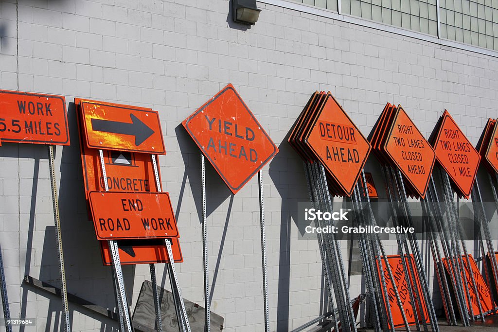 Awaiting Construction: Dozens of Road Signs  Men At Work Sign Stock Photo