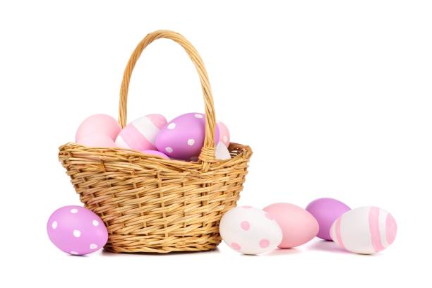 istock Easter basket with pink, purple and white Easter Eggs over white 913199934