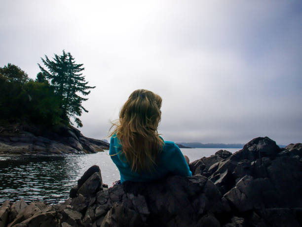 istock Woman Looking Out at Pacific Ocean in Tofino BC 913200546