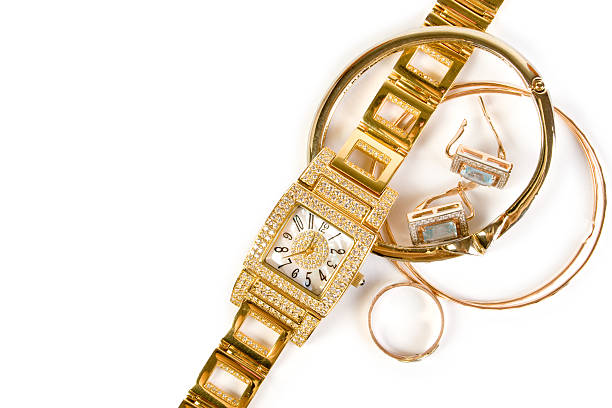 golden ladies watch with a metal bracelet, chronometer, precious stones, diamonds on a black background with reflection. The concept of an expensive gift for women, luxury. Close-up, macro. High quality photo