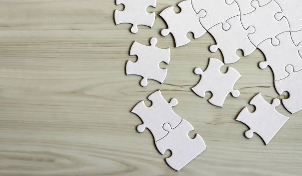 Pieces of puzzles on the wooden table. stock photo