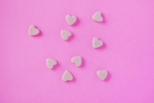 istock valentine candy hearts shape on pink background 913213818