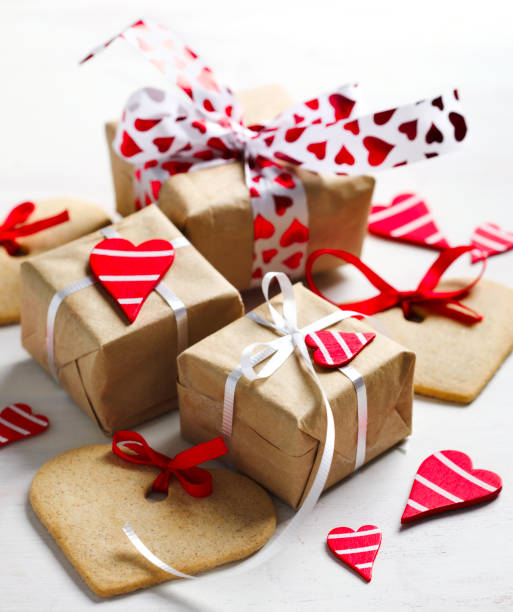 istock Gift boxes with decorative red hearts and heart shaped cookies. Festive background. 913221048