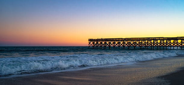 Storm seems to be brewing the horizon beyond a Fishing Pier on the Gulf of Mexico at Naples Florida