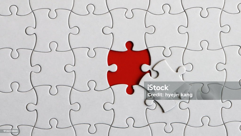 A piece of a puzzle and a missing piece of the puzzle. Puzzle Stock Photo