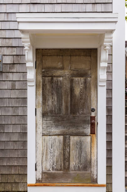 istock Weathered brown front door of a beach house 913230932